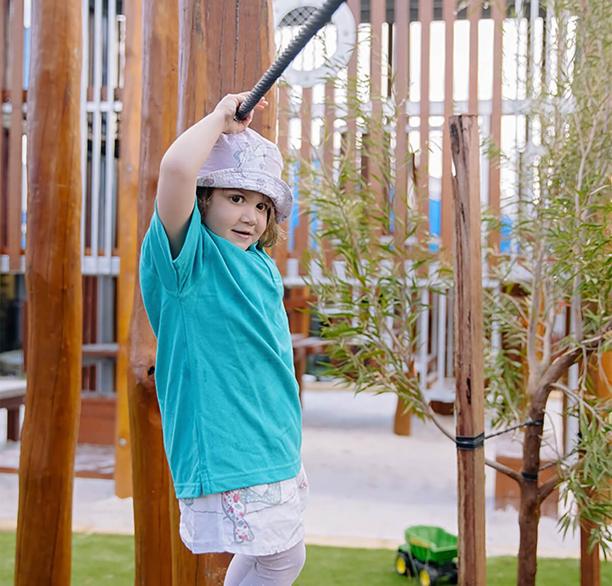 A girl child playing at nido child care garden area